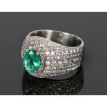 Impressive emerald and diamond set platinum ring, the oval emerald at an estimated 1.58 carat with a