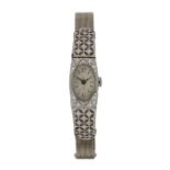 Ladies platinum and diamond set cocktail watch, the oval dial with Arabic numerals, manual wound,