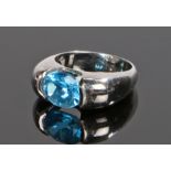 18 carat gold blue topaz set ring, with an oval blue topaz to the head, ring size M