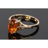 9 carat gold ring, with an oval facetted orange stone, ring size O 1/2