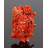 Victorian coral brooch, carved as a portrait bust and rose surround, 60mm long