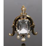 Topaz and pearl pendant, with a central topaz at 31.95 carats and arched scroll sides and pearl