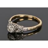 18 carat gold diamond set ring, with a round cut diamond to the head and petal diamond set