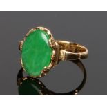 Jade and gold set ring, with an oval jade to the head, ring size K