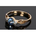 18 carat gold sapphire and diamond set ring, the central oval sapphire flanked by a round cut