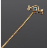 Blue topaz and pearl set stick pin, the central topaz flanked by pearls