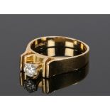 18 carat gold diamond set ring, the round cut diamond held with six claws above the sunken