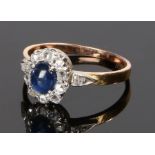 Sapphire and diamond set ring, with a cabochon cut sapphire and diamond surround, ring size N