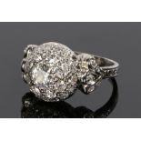 Diamond set ring, with a dome diamond set head and diamonds to the shoulders, with an estimated