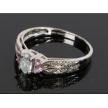 9 carat gold aquamarine and pink topaz set ring, with a central aquamarine flanked by pink topaz,