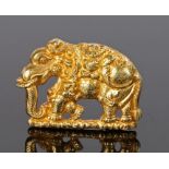 Indian gold mount, as an elephant walking in ceremonial dress, 35mm diameter
