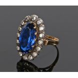 Victorian glass ring, the head with an oval facetted stone and clear glass stone surround, ring size