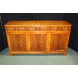Yew wood sideboard, with a rectangular top above three short drawers and three cupboard doors, 150cm