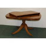 Regency style yew wood extending dining table, the rectangular top with slide leaves and an