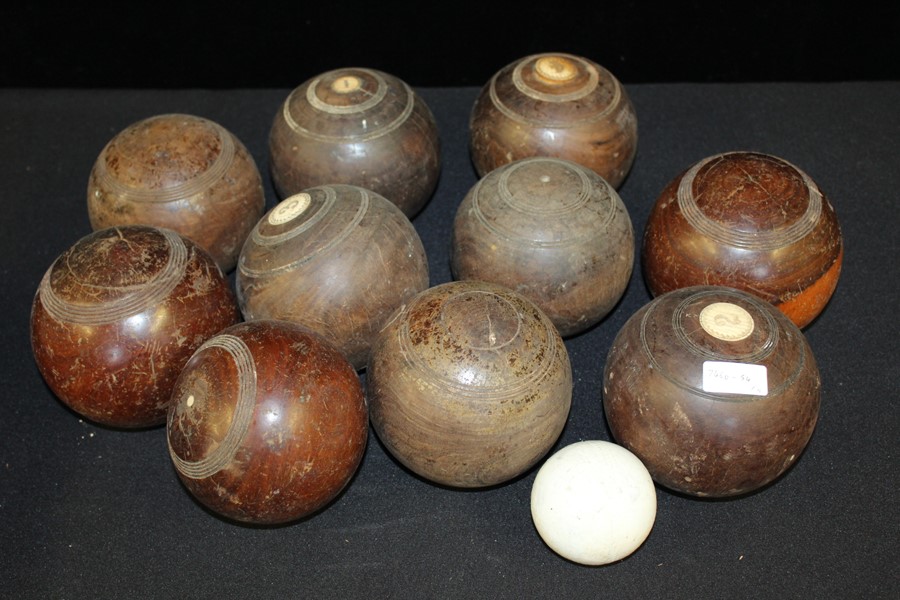 Ten lignum vitae bowling bowls, some with numbered ivory roundels, together with a jack (11)