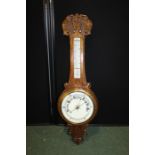 Oak aneroid barometer. with a thermometer and weather gauge, 85cm long