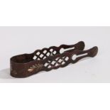 Pair of Toleware sugar tongs, in deep red with a leaf and flower design, 12cm long