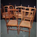 Harlequin set of eight bedroom chairs, with shaped splat backs and cane seats, on turned and