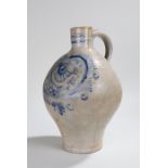 17th Century pottery flask, with loop handle and underglaze blue scroll decoration, 36cm high