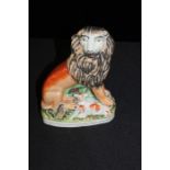 Staffordshire figure depicting a lion.and lamb, 16.5cm high
