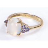 9 carat gold moonstone set ring, the cabochon cut moonstone with purple stones to the sides, 3