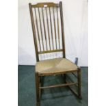 Oak rocking chair, with shaped cresting rail, turned spindle back, on turned legs and stretchers