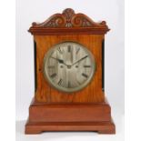 19th Century mahogany and walnut mantel clock, the scroll top above a rectangular case and plinth