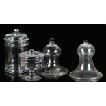 Four glasses, to include two glass jars, with lid tops to the bases, 32cm high and 19cm high, also