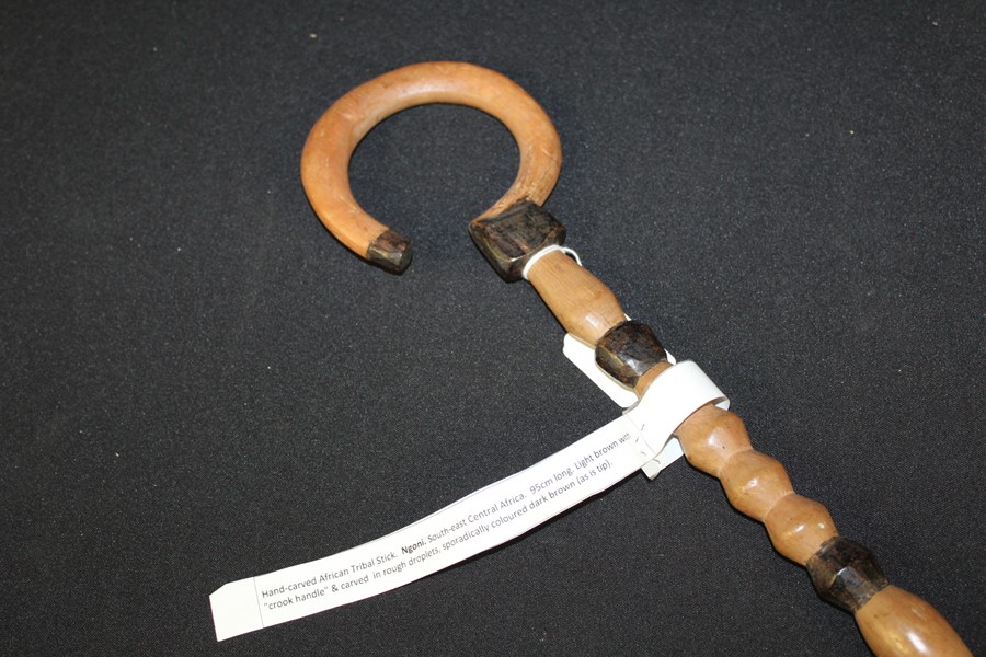 African tribal stick, the handle carved in the form of a crook, with carved stem, 95cm long
