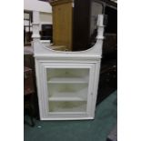 Victorian white painted pine standing corner cupboard, the glazed door opening to reveal two