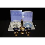 Venetian glass liqueur set, the blue glass bodies with gilt and raised floral decoration, consisting