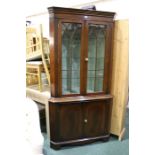 Mahogany standing corner cupboard, with stepped pediment above two gothic style astragal glazed