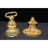 Two gold painted doorstops, with cast scroll and acanthus leaf decoration, the largest 18cm high