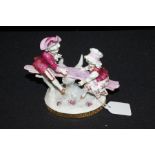 Continental porcelain figure, depicting a young boy and girl on a see-saw