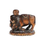 Japanese Meiji period signed netsuke, the wood netsuke depicting Boy with Ox, the boy appearing to