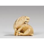 Fine Japanese Edo period netsuke, the ivory netsuke carved as a Kyoto goat, seated and looking to