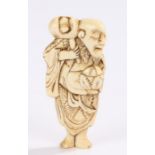 Japanese Meiji period ivory netsuke, Elderly figure standing bare foot, 8cm high