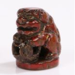 Japanese Edo period boxwood and lacquer netsuke, late 18th Century, seated Karashishi in seal form