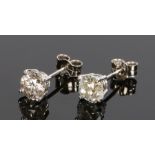 Pair of diamond ear studs, the round cut diamonds at approximately 0.75 carat with four claws to the