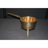 18th century style brass eight pint saucepan, raised on three splayed legs, the handle cast with the