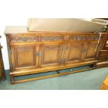 Old Charm oak sideboard, with four foliate carved frieze drawers above four linen fold panelled