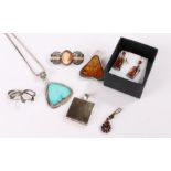 Jewellery, to include an amber style pendant, a pair of earrings and a garnet set pendant, also