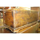 Dark stained pine blanket box, with hinged lid, raised on bracket feet, 109cm wide