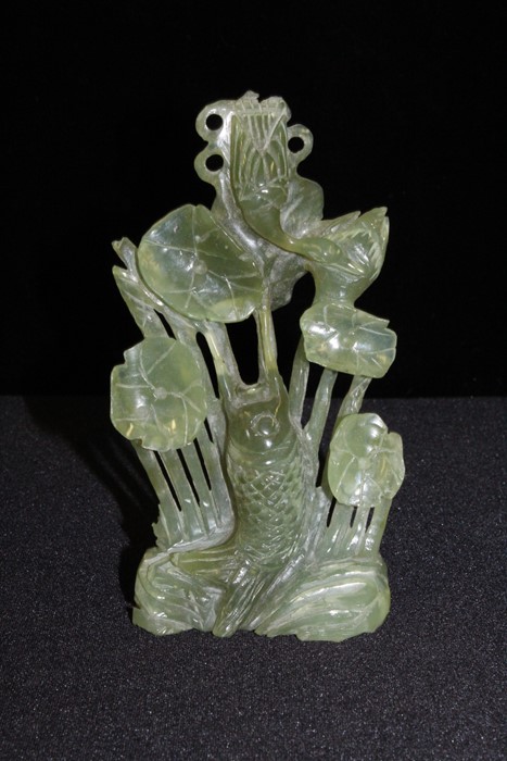 Chinese jadeite carved koi carp amongst water lilies, 15cm high