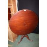 19th Century mahogany breakfast table, the circular tilt top on a turned stem, tripod legs and pad