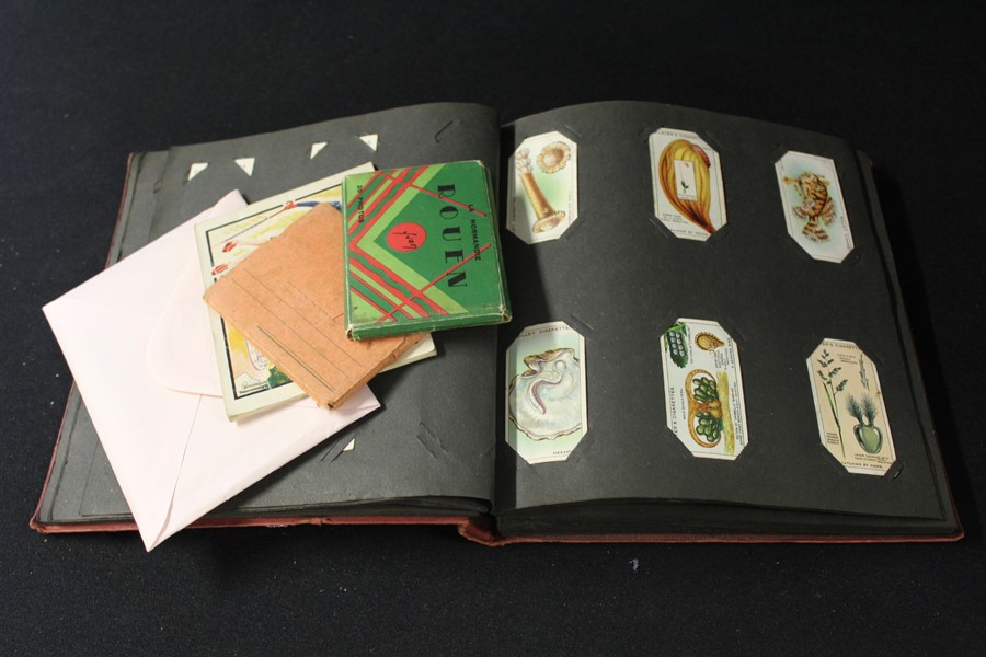 Cigarette card album containing Will's and Player's cards, to include cricketers, flags of the