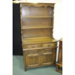 Old Charm oak dresser, the shaped pediment with turned finials above two shelves, the base with