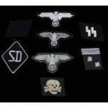 Collection of reproduction German Third Reich SS insignia, sleeve eagles, collar tabs, 'SD' diamond,