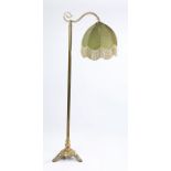 Early 20th Century brass standard lamp, with an arched top rail above the column and a splayed