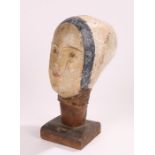 19th Century French papier mache mannequin head, near life size raised on a plinth base, 34cm high